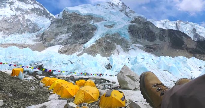 Feet of tourists in the background Everest base camp in the mountains of the Himalayas in Nepal at 5350m a.s.l the Khumbu camping. 
