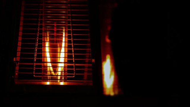 Fire burning inside contemporary metallic decorative lamps in the dark.