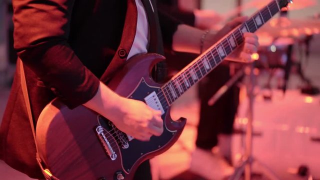 Man playing guitar on concert closeup