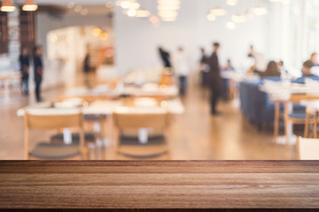 Empty wooden table space platform and blurred restaurant interior