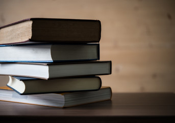 Stack of books on wooden table. Education concept.