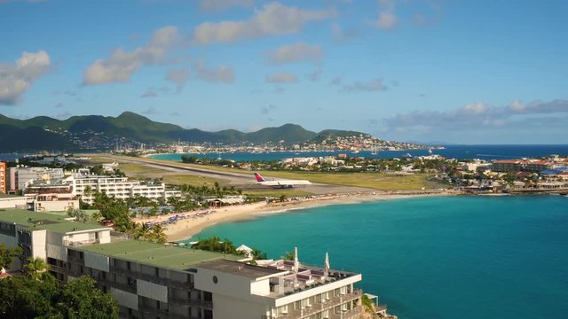 St Maartin Aerial v57 Flying low over Maho Reef area with views of commercial airplane taxiing.