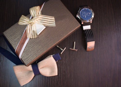 The range of fashion mens accessories as a gift on a brown background