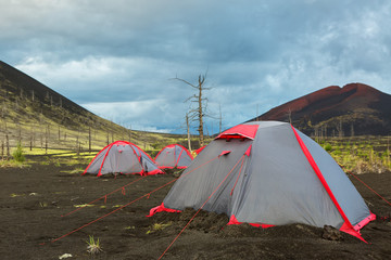 Tourist tent in Dead wood - consequence of catastrophic release of ash during the eruption of volcano in 1975 Tolbachik