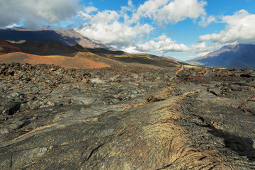 Lava field at Tolbachik volcano, after eruption in 2012 on background Big Udina volcano and Plosky Tolbachik volcano, Klyuchevskaya Group of Volcanoes