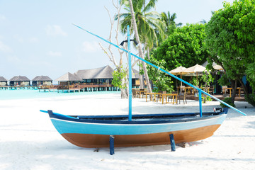 Naklejka na ściany i meble sail boat on beautiful tropical beach in blue sunny sky