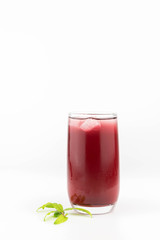 Glass of pomegranate juice with fruit isolated on white.