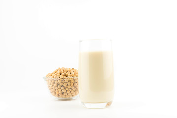 soy milk with soy beans on white background