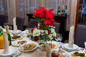 Red flower is on the banquet table. Corporate banquet