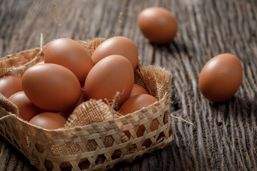 Brown Egg in a basket on wooden table, Chicken Egg