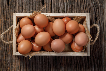 Brown eggs in wooden box on wooden table, Chicken Egg
