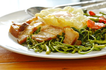 stir fried water minis with crispy topping egg on rice