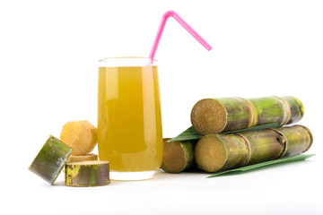 Fresh sugar cane juice in glass on white background