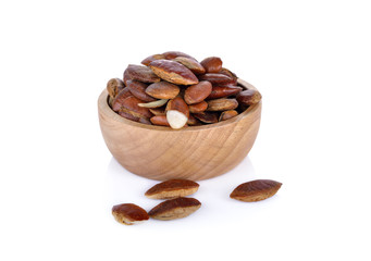 Barking deer's mango or Wild almond seed in wooden bowl on white background