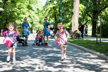 Fototapeta premium twins mother with children in city park