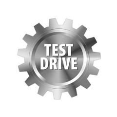 Gray metal gear with words 'Test Drive' on white background. Steel label for industrial companies, car shops, parts stores. Vector design element.