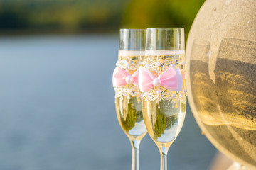 two glasses of champagne on the background of the lake