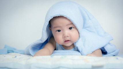 baby boy is hiding under the blue blanket,asian baby,baby in home,thailand baby boy,happiness baby