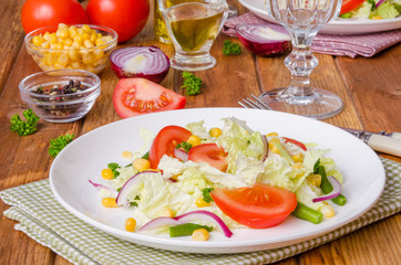 Salad with Chinese cabbage, tomatoes, corn, green beans and onion. Healthy dish.