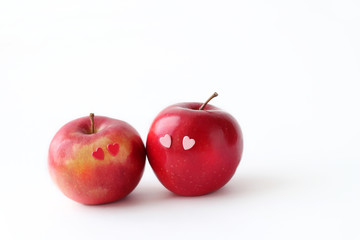 Two lovely red apples with hearts eyes on white background. fresh fruit apple. symbol of love, Valentine's day. minimal style. element for design. copy space