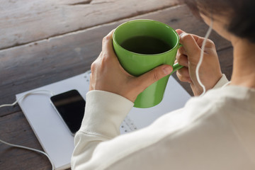 Woman wear headphones surfing the net by smart phone