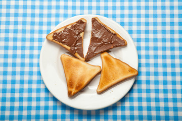 Toasts and chocolate on a blue table