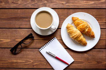 Business breakfast with coffee and croussant top view