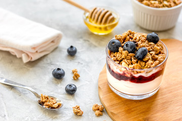 Healthy breakfast from yoghurt with muesli and berries on kitchen table