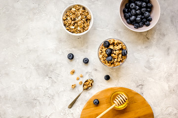 Oat flakes and berries granola glass on table background top view