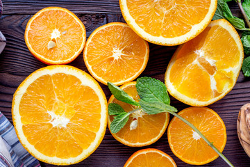 orange juice with mint squeezing on wooden kitchen background top view