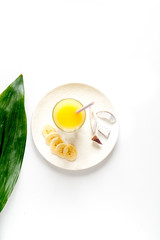 cocktail with coconut on white background top view