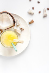 cocktail with coconut on white background top view