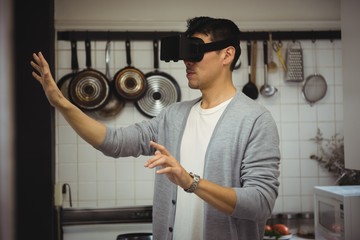 Man experiencing virtual reality headset in kitchen