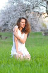 Fototapeta na wymiar girl sitting on the grass in spring