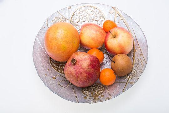 mix fresh fruits on plate isolated on white