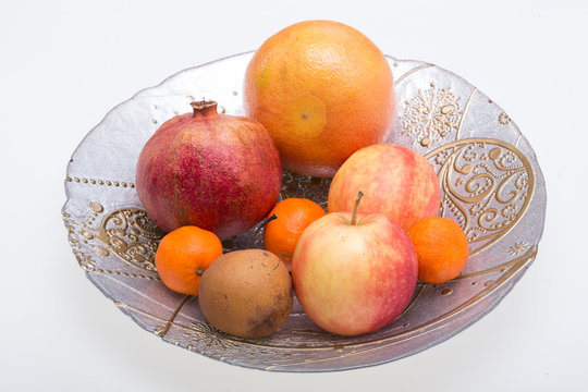 mix fresh fruits on plate isolated on white