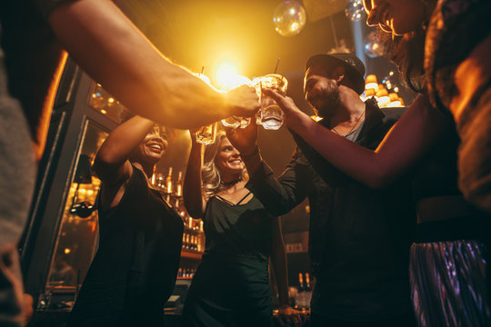 Group of friends enjoying drinks at bar