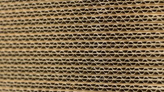 Extreme close up / macro slide of stacked cardboard boxes. Ideal for paper, packing or recycle  projects. 4K, 60fps