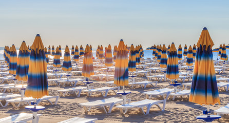 The Black Sea shore, blue clear water, beach with sand, umbrellas and sunbeds. Morning. Resort Albena, Bulgaria