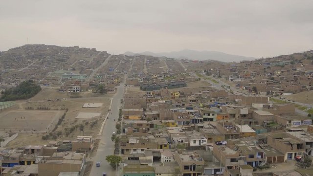 Ventanilla Peru Aerial v1 Flying low over urban poverty hillside housing area.