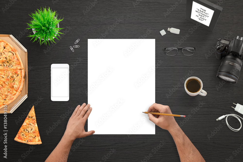Aufkleber Designer or photographer sketching on empty white paper. Camera and mobile phone beside. Top view of black work desk.