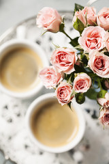 Romantic setup with coffee and roses in vase