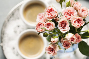 Romantic setup with coffee and roses in vase