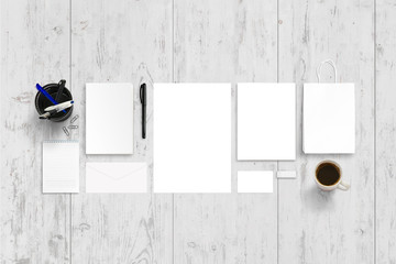 Empty stationery, office accesories for branding promotion. Top view of white wooden desk.