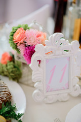 Number 11 put in original white frame stands on dinner table