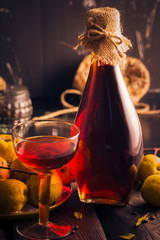 cup alcohol wooden table ingredients tincture quince