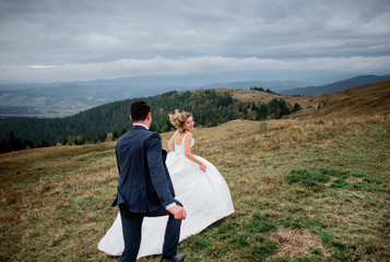 The brides running along hillside