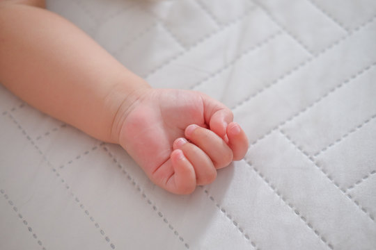 Close up of a small hand the sleeping baby.Little infant child baby kid hand.
