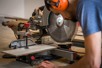 a man working with a miter saw