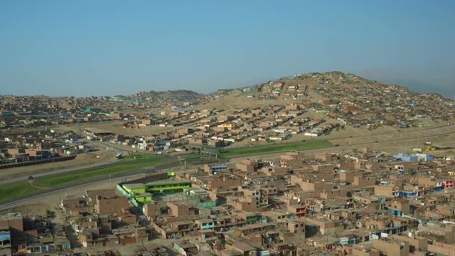 Ventanilla Peru Aerial v9 Flying low over urban poverty hillside housing area in Mi Peru.